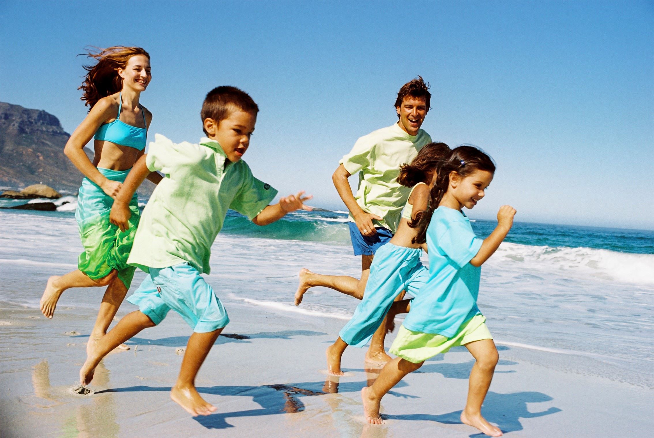 Happy Family Running Beach