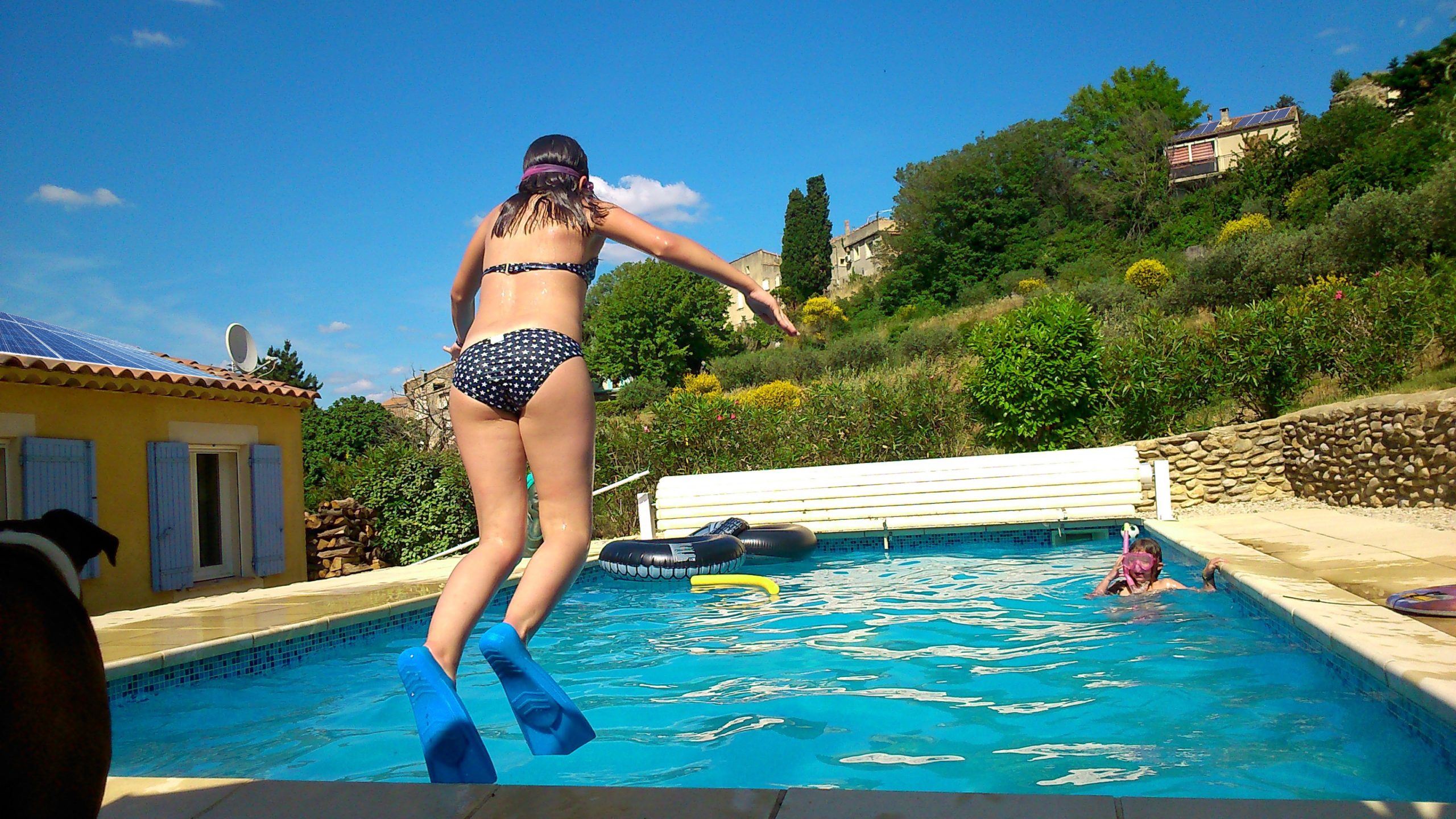 lady jumping into swimming pool