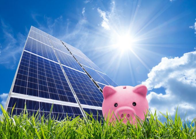 Piggy bank in front of solar panel