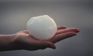 hands with ice ball