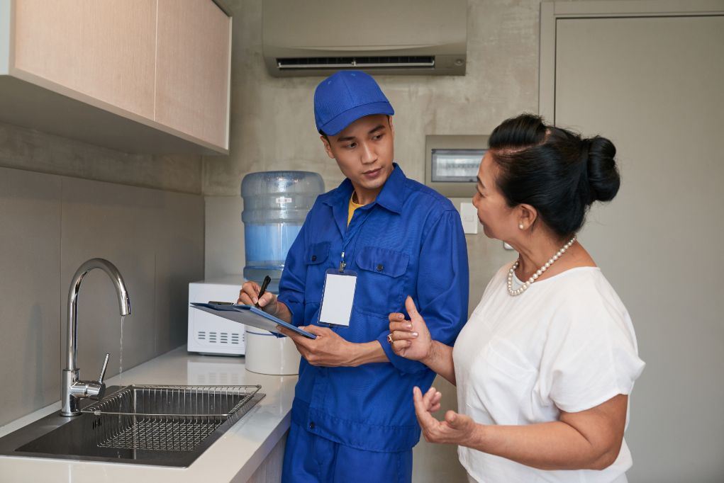 Man with clipboard talking to customer