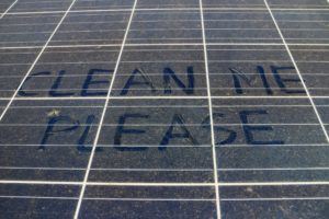 please clean mean written on dirty solar panel