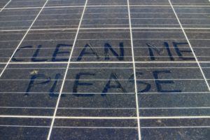 please clean mean written on dirty solar panel