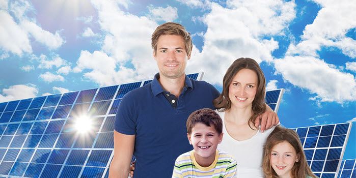 family in front of solar panels