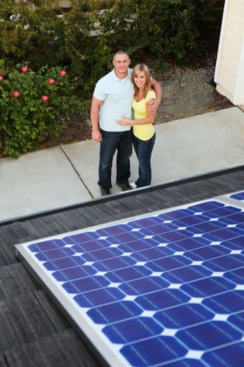Aerial view of couple outside house with solar