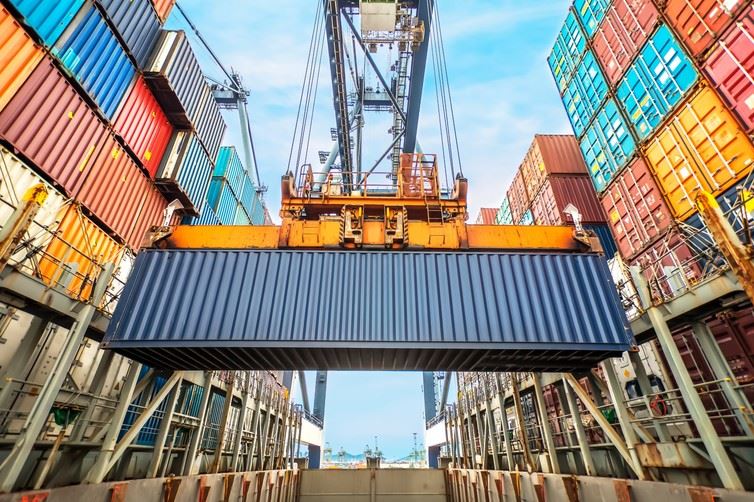 shipping container being lifted with crane