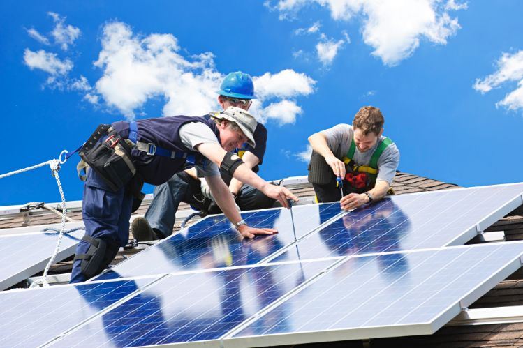 men installing solar