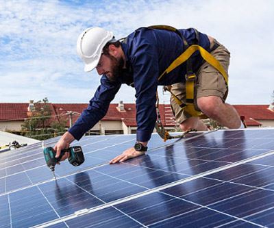 man installing solar