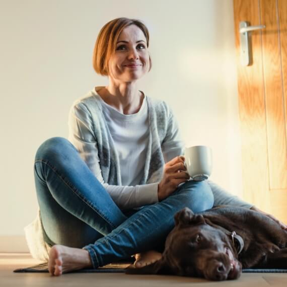 Woman sitting on the floor with her dog