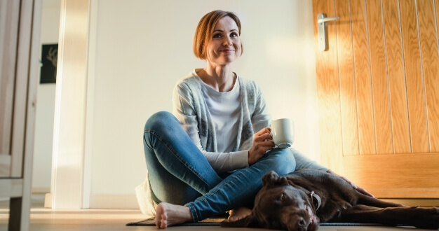 Woman sitting on the floor with her dog